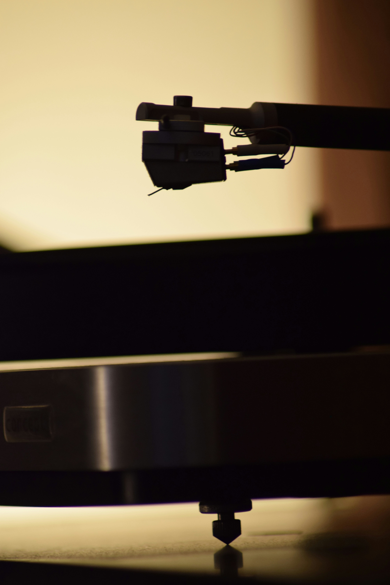 Close-up of a turntable cartridge in silhouette